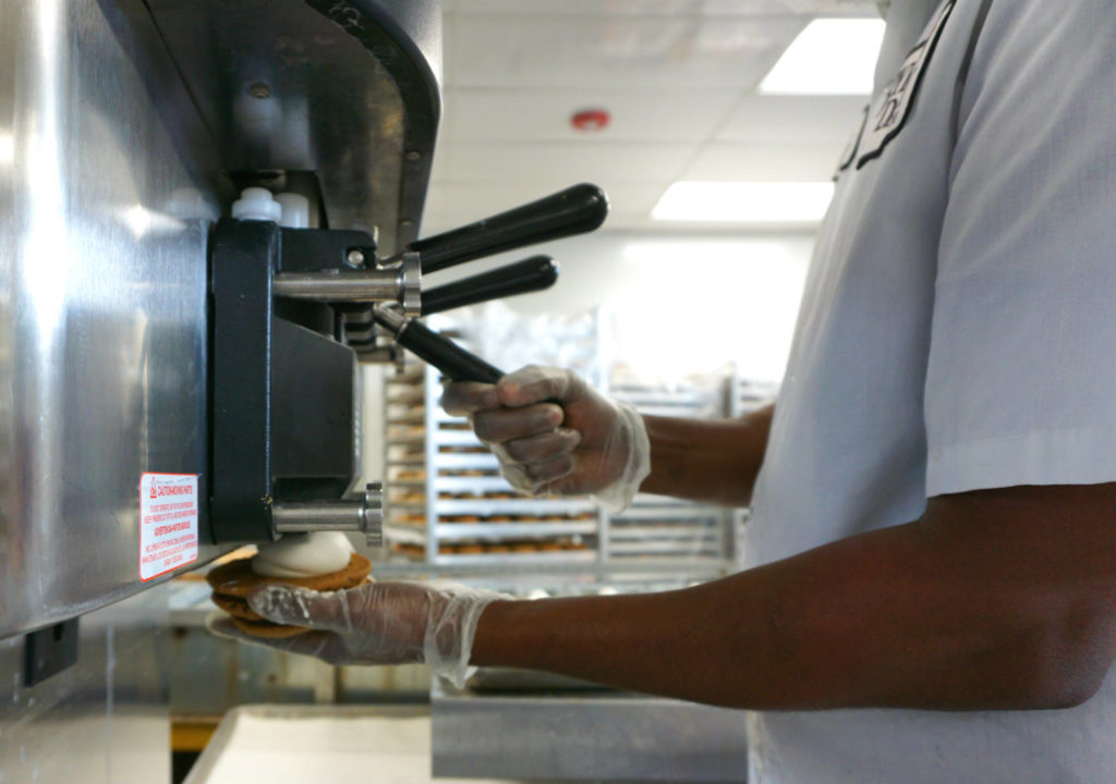 Putting Ice Cream on Byrne Dairy's Cookiewich at the Ice Cream Center in Syracuse, New York