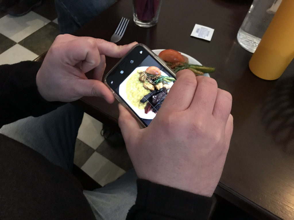 Chris Lindstrom Taking a Photo at Hawi in Ithaca, New York, Tompkins County