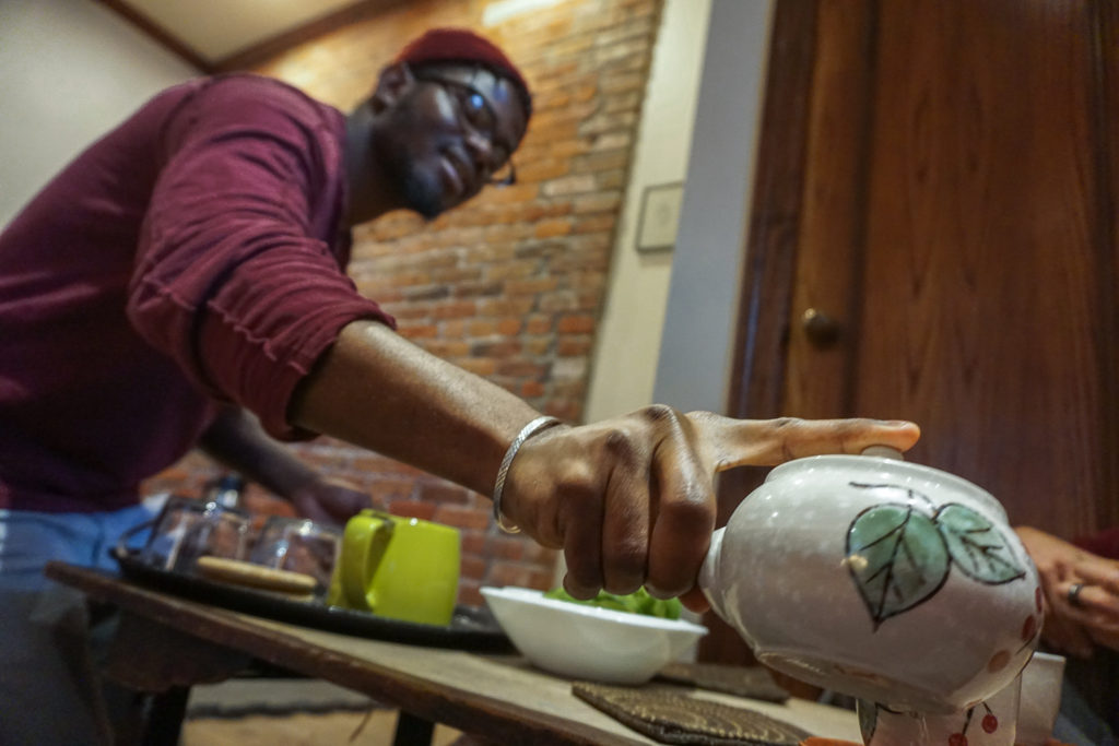 Employee Pouring Tea at the Roji Tea Lounge in Syracuse, New York