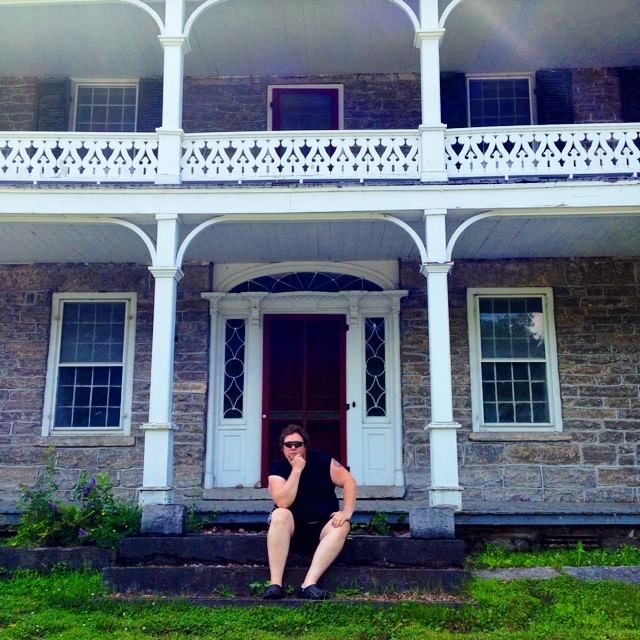 Michael Brewster on the steps of the Old Stone House in Talcottville